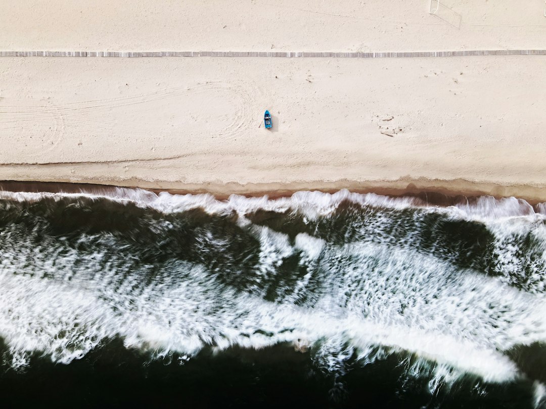 Person surfing on sea waves during daytime